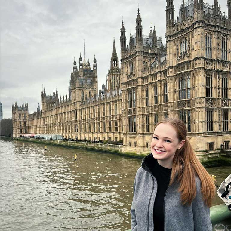 Student standing outside a building while studying abroad