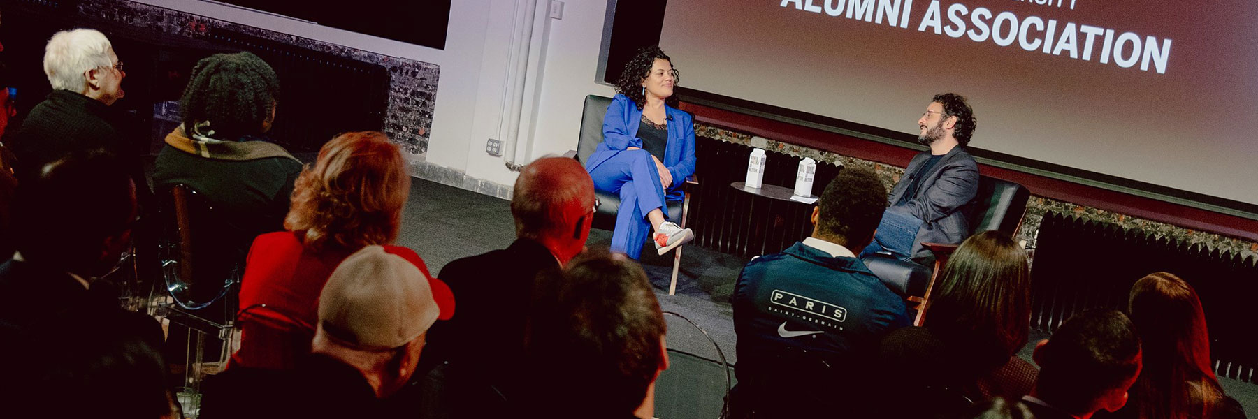 Alumni Shanta Thake and Arian Moayed talk during an alumni event.